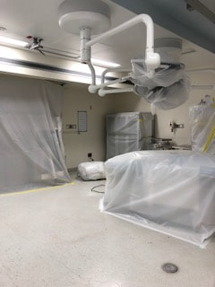 Plastic sheeting protects medical equipment from duct and debris during the air duct cleaning service