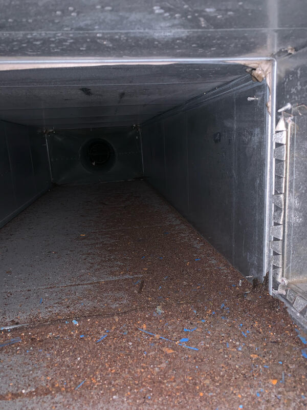 Dirty commercial air duct filled with debris
